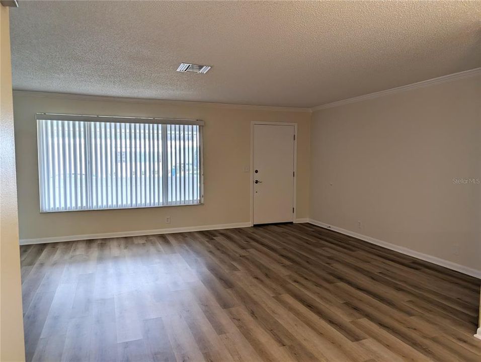 View from dining room thru living room to front entry.