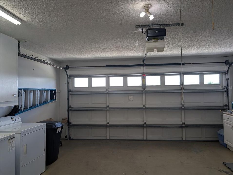 Reinforced garage door with a keyless entry pad on exterior side.