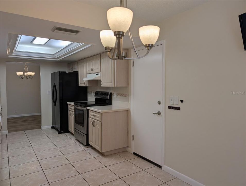 View thru kitchen to dining room.  Garage access door to right.