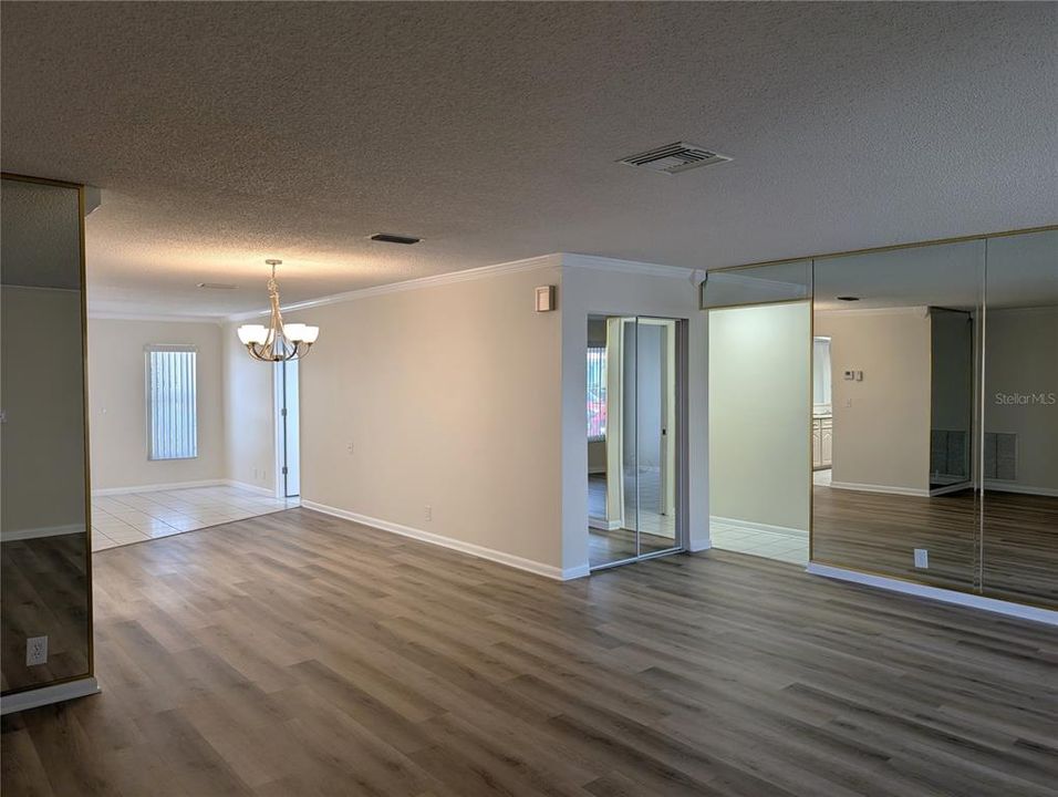 View of hallway and linen closet from front entry of living room.  Master bath access is also visible in Florida room.