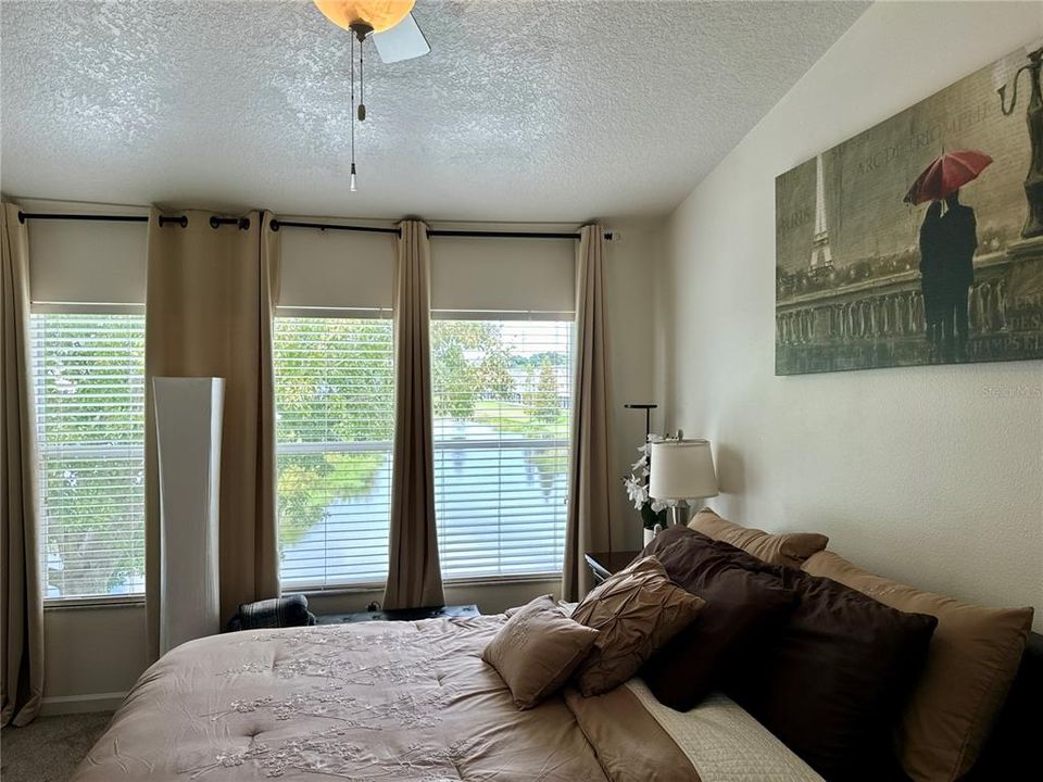 Primary bedroom overlooking pond