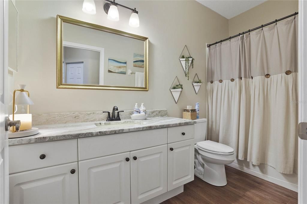 Guest bathroom w/ granite countertop vanity & tub/shower combo