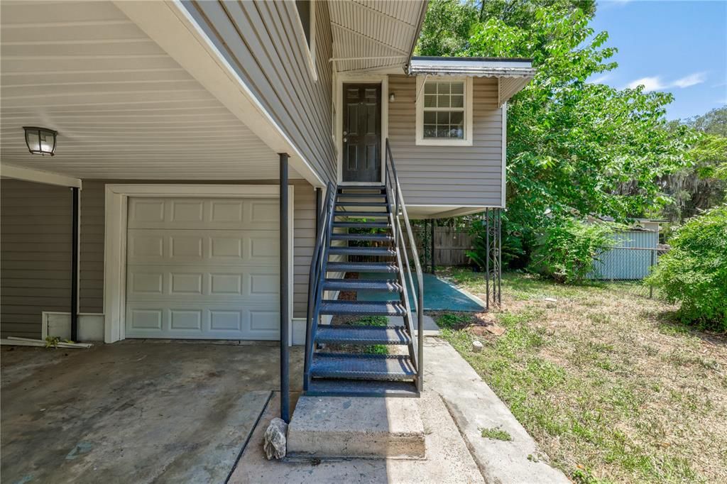 Front - Covered carport, laundry, garage on main