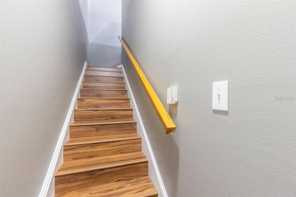 Stairwell from bonus room and attached garage to condo