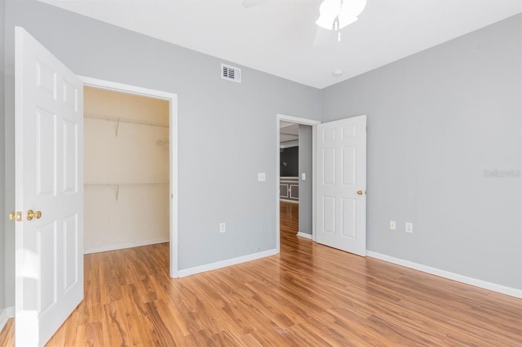 Primary bedroom with built-in shelving and walk-in closet