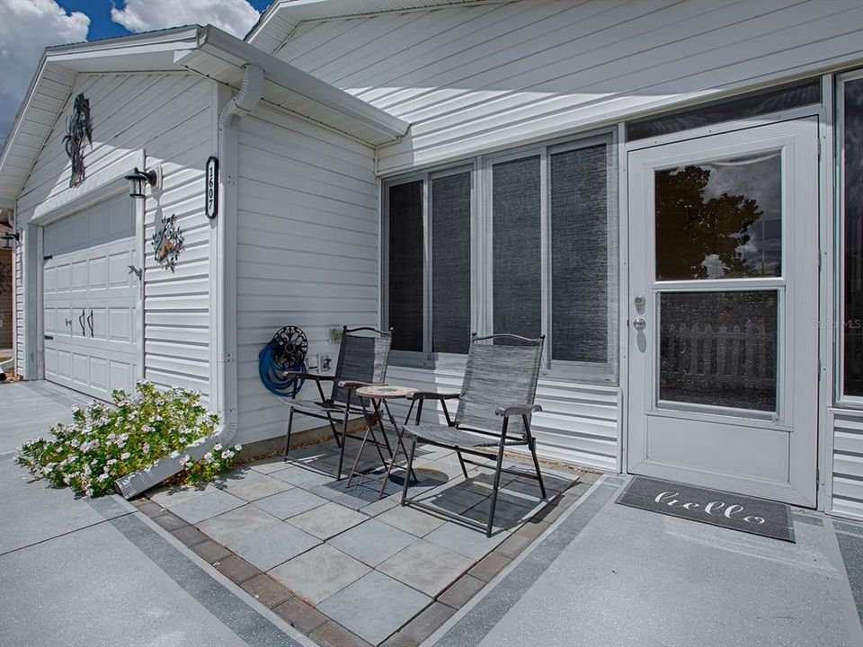 CONVENIENT PAVED FRONT PATIO FOR OUTDOOR ENJOYMENT.