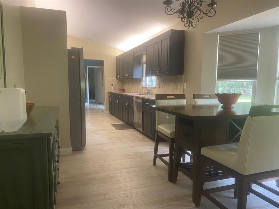 Elongated View of Kitchen and Breakfast Nook.