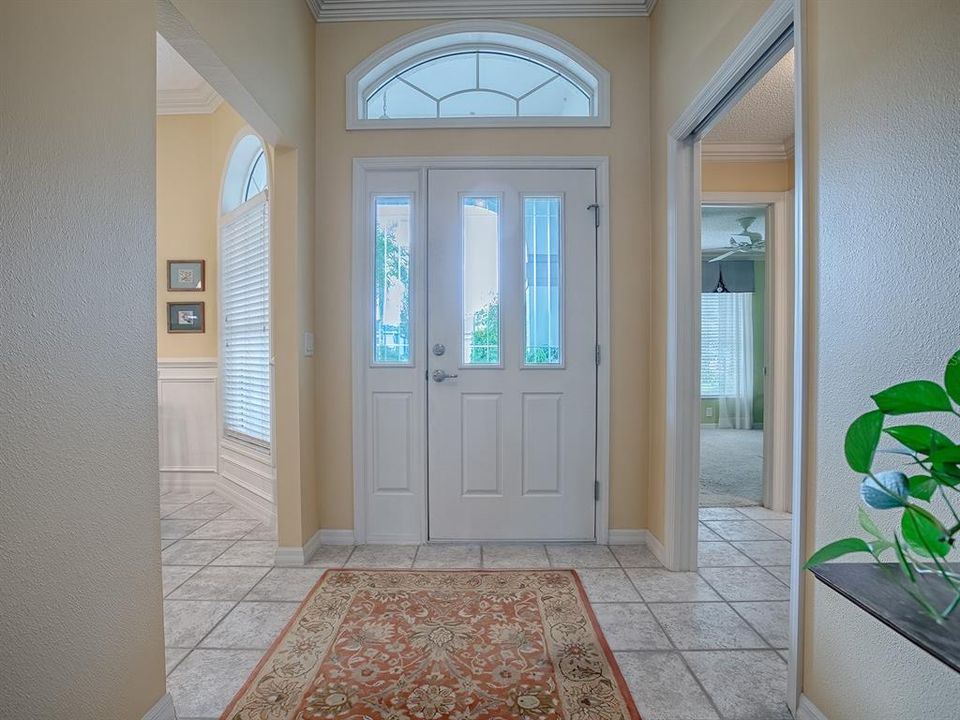 FOYER WITH CERAMIC TILE -  THE POCKET DOOR TO THE RIGHT LEADS TO THE PRIVATE GUEST SUITE, AND TO THE LEFT IS THE KITCHEN.