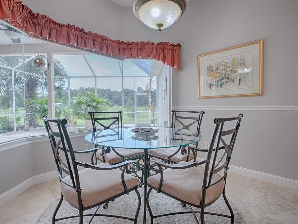 Breakfast nook features gorgeous mitered glass window