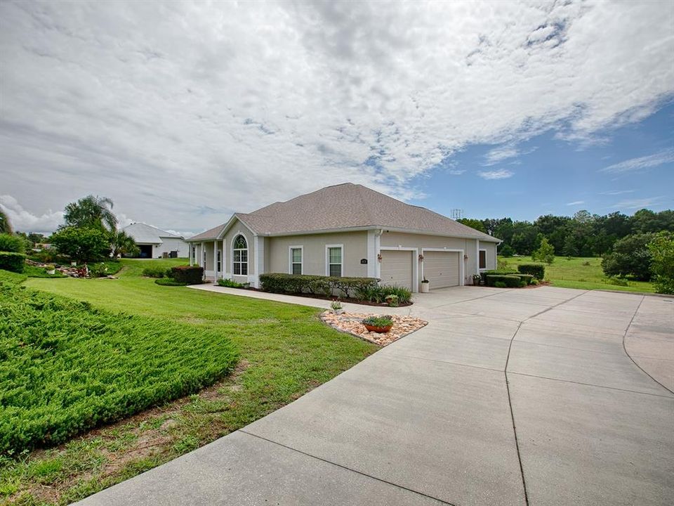 3 car side entry garage with extra parking pad!