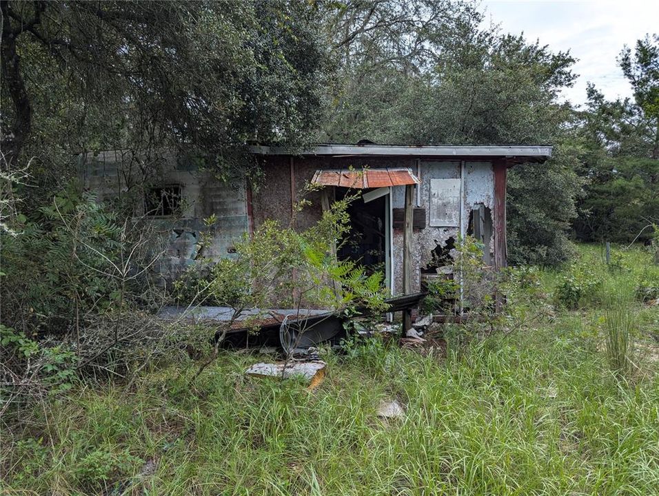 Side of the shed and camping trailer. DO NOT ENTER.