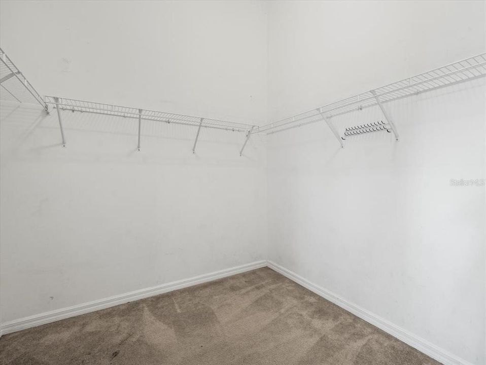 Spacious primary bedroom walk-in closet.