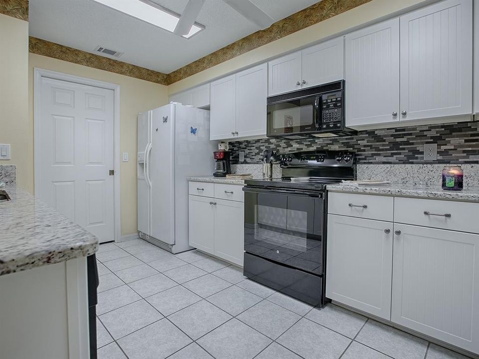 BEAUTIFUL  BACKSPLASH AND COUNTERTOPS IN THE KITCHEN