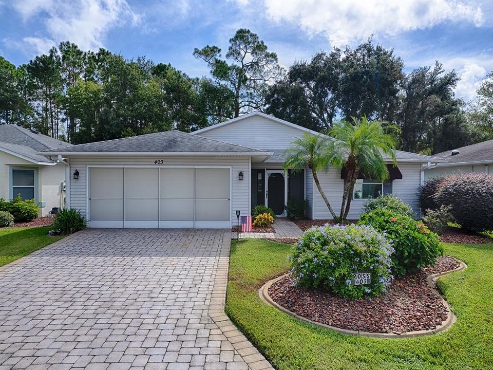 BEAUTIFUL MANICURED LANDSCAPING, PAVERED DRIVEWAY AND A SCREENED PORCH!