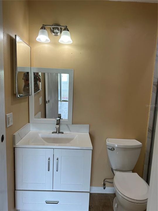 New powder room with new vanity and toilet