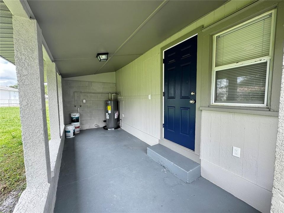 Back porch. Laundry hook up and water heater is here.