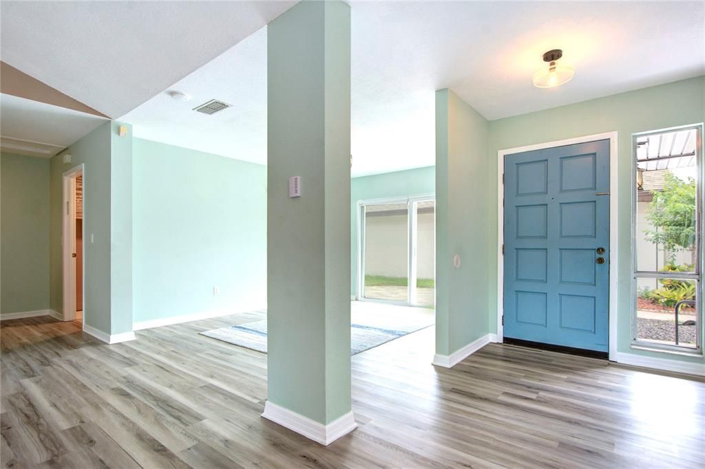 INSIDE LOOKING AT FRONT DOOR WITH DINING ROOM ON LEFT