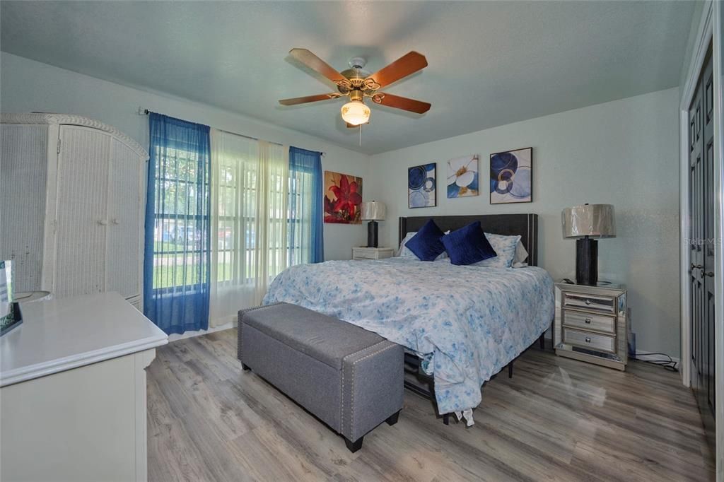 Guest bedroom with large front windows