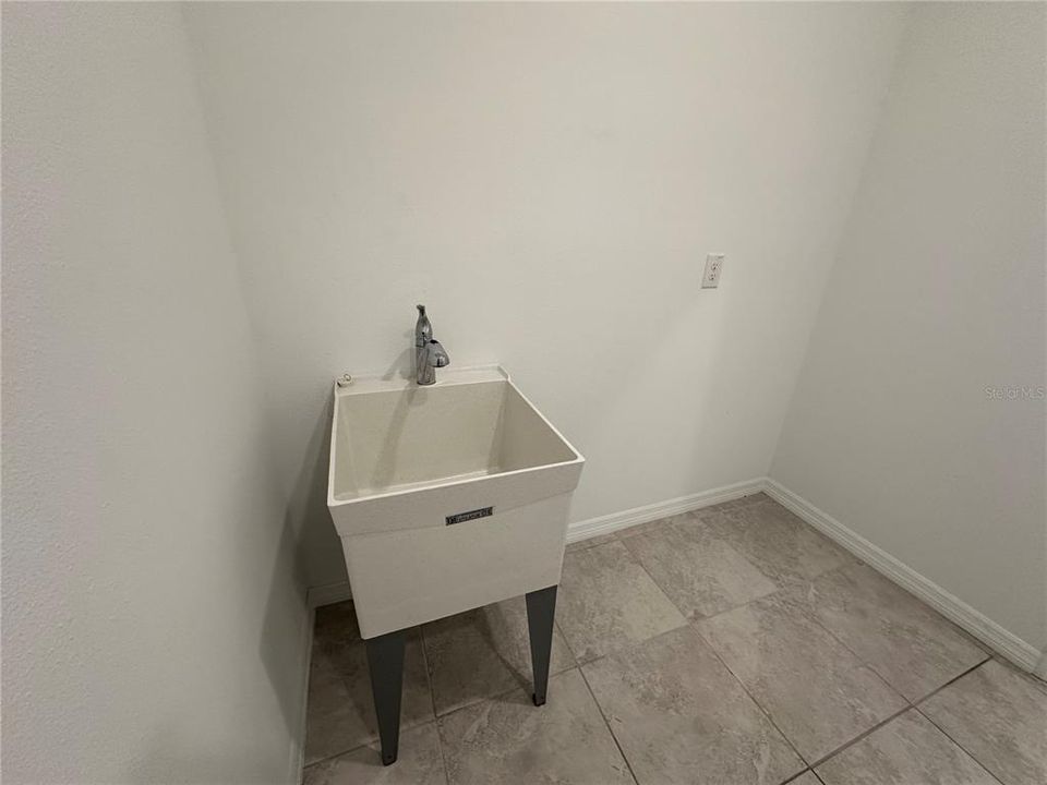 Washer/ Dryer in Laundry Room  with Utilities Sink