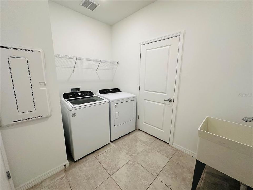 Washer/ Dryer in Laundry Room  with Utilities Sink