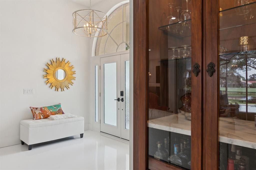 Foyer and dry bar with antique doors