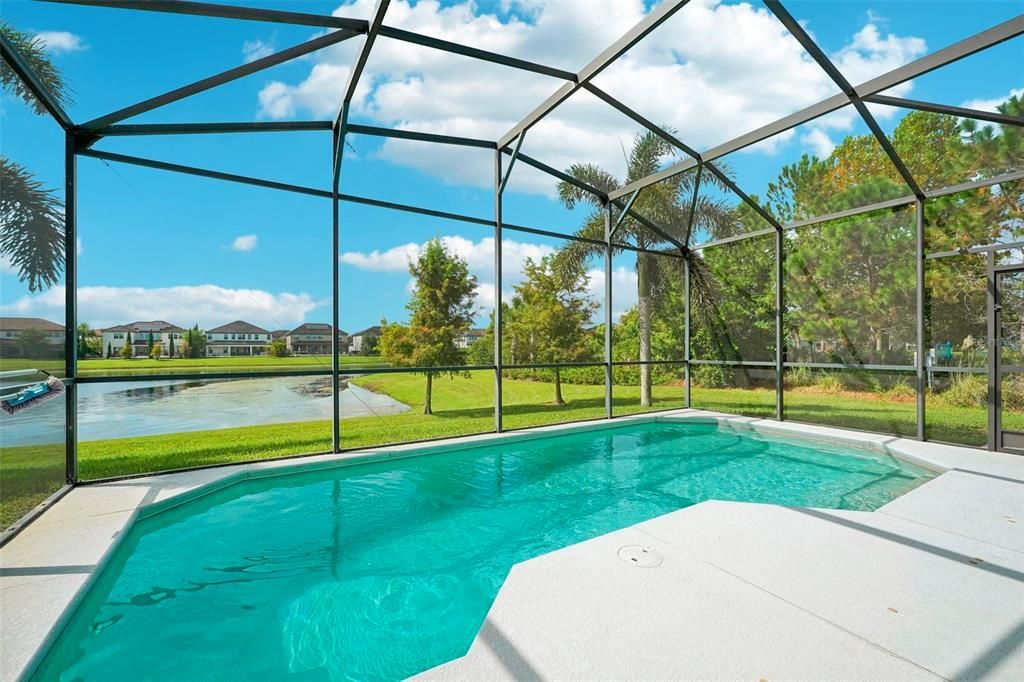 This home enjoys no neighbors to the right where you will find the community park/playground and the pond behind is the perfect backdrop to the SCREENED POOL and COVERED LANAI!