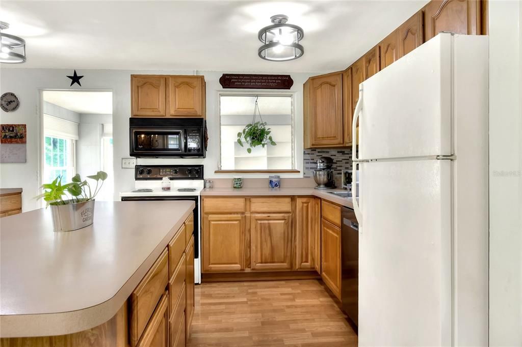 The Kitchen has beautiful wood cabinets and attractive back splash