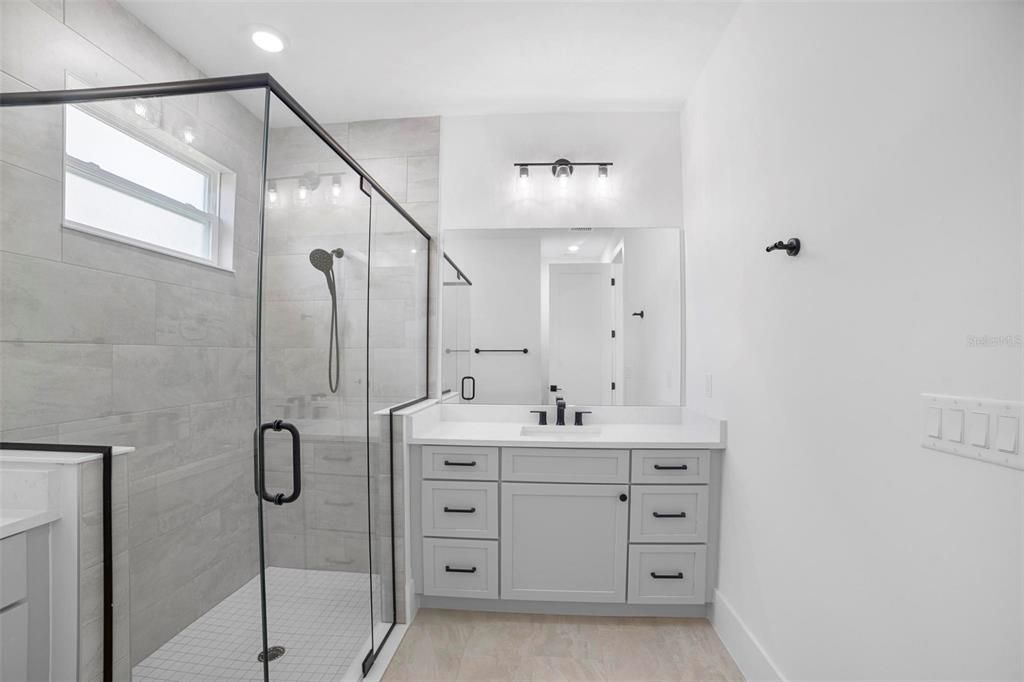 Master Bathroom with dual vanities and custom glass shower enclosure