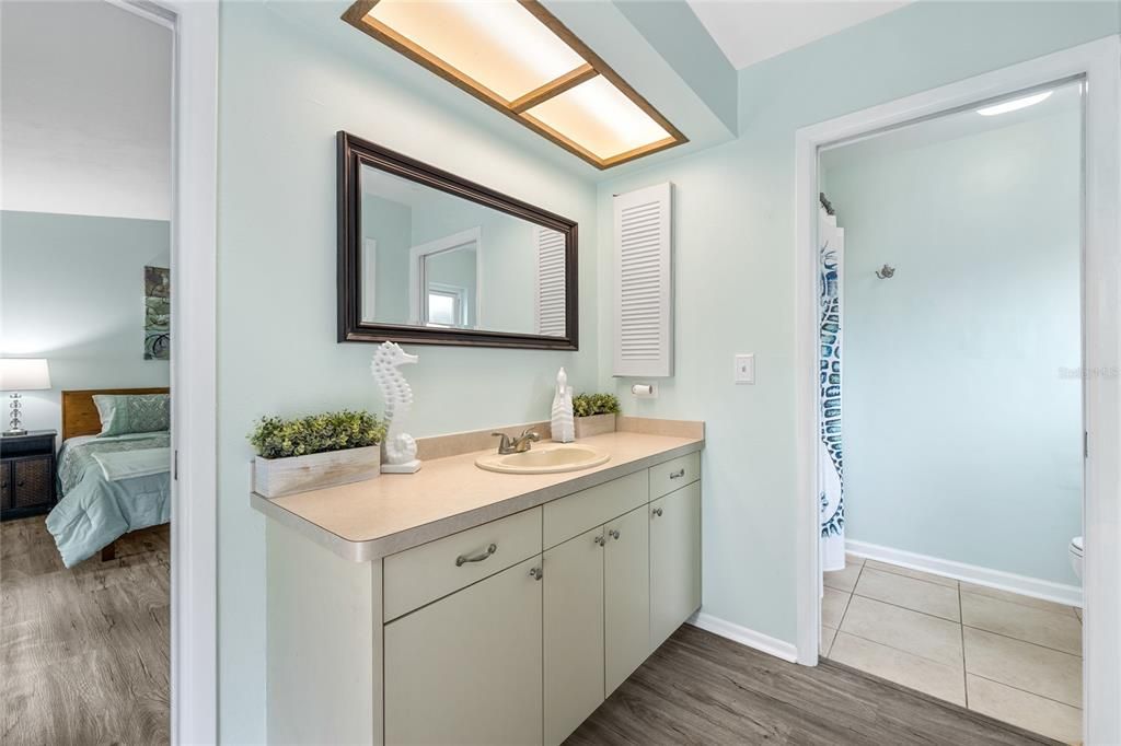 The Primary Bathroom has a large single sink vanity and a private shower and toilet room.