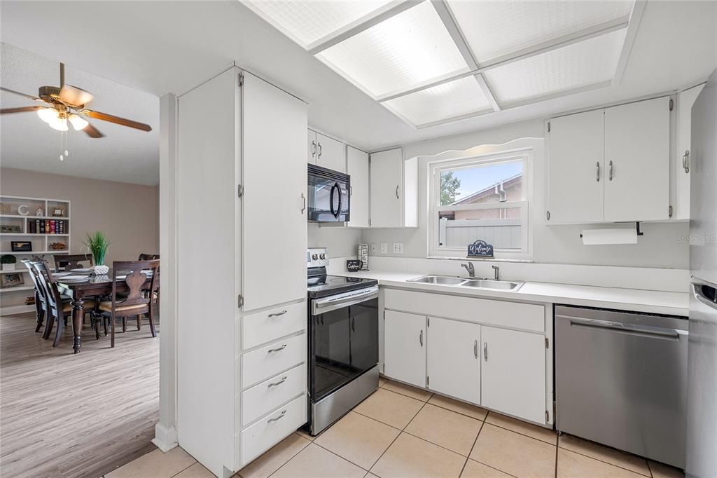 This light and bright kitchen is a blank canvas.   Will you keep it as is?     Or open the wall up and update it?