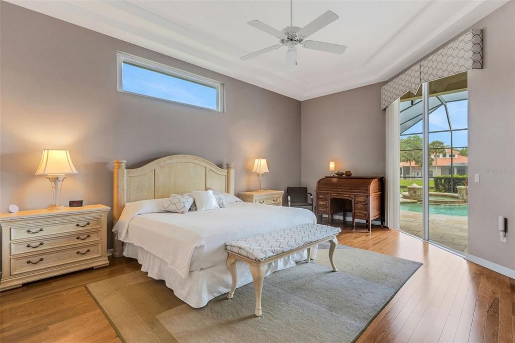 Primary bedroom with slider to lanai and transom window for beautiful natura light