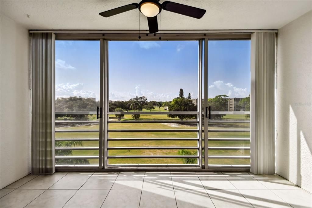 The sliding glassed lanai overlooking the golf course.