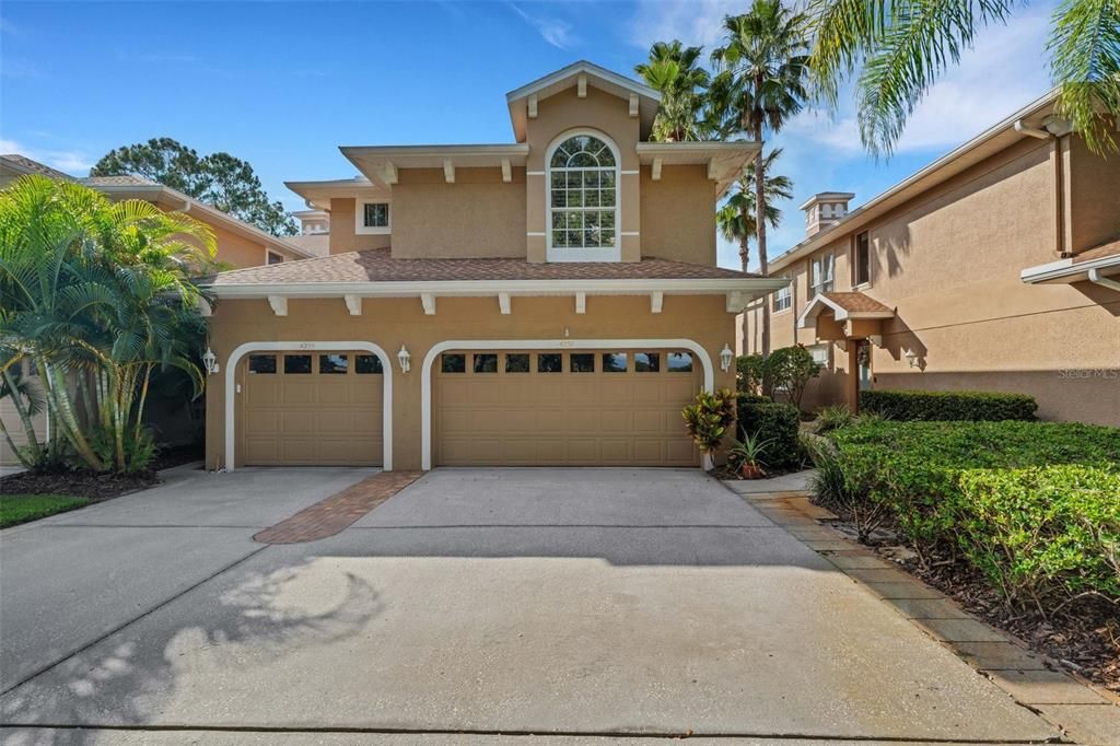 Condo is on the right with a two-car garage. One car garage belongs to the condo on the first level.