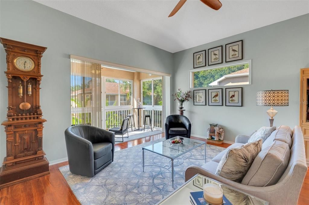 Formal living room with slider to lanai that overlooks the pond