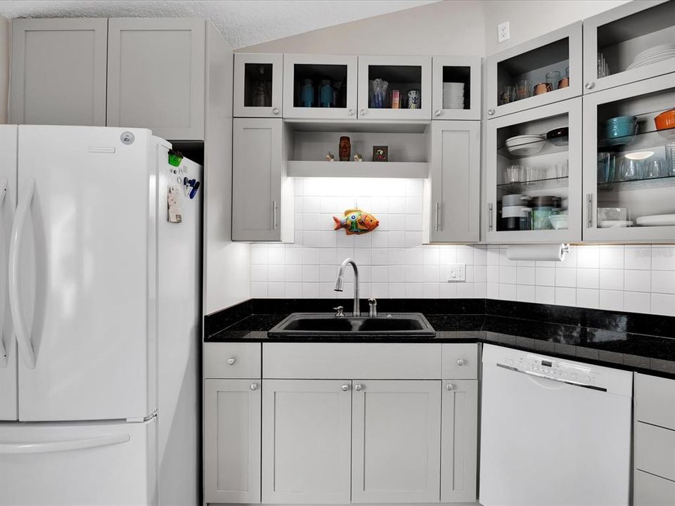 Kitchen appliances include dishwasher, refrigerator, range & microwave