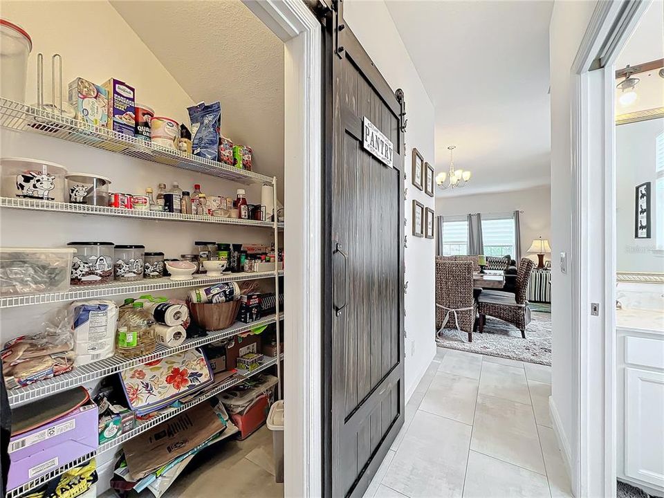 Walk-in pantry with upgraded sliding barn doors.