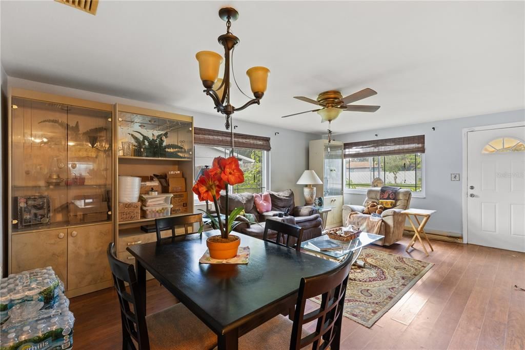 Living room /Dining Room featuring laminate flooring and large windows.