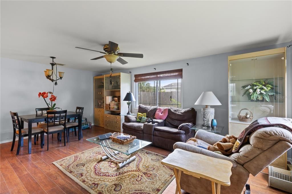 Living room /Dining Room featuring laminate flooring and large windows.