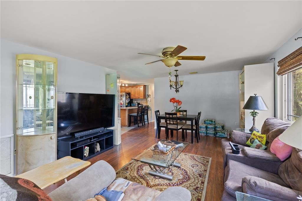 Living room /Dining Room featuring laminate flooring and large windows.