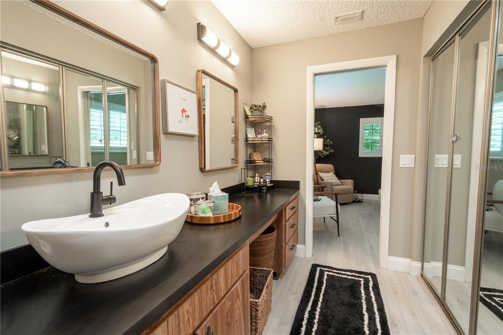 The primary bath features a new countertop, vessel sink and faucet.