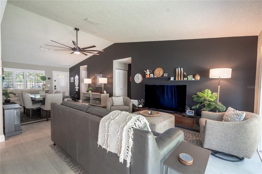 The living room is a show-stopper with stunning accent wall, and vaulted ceiling.