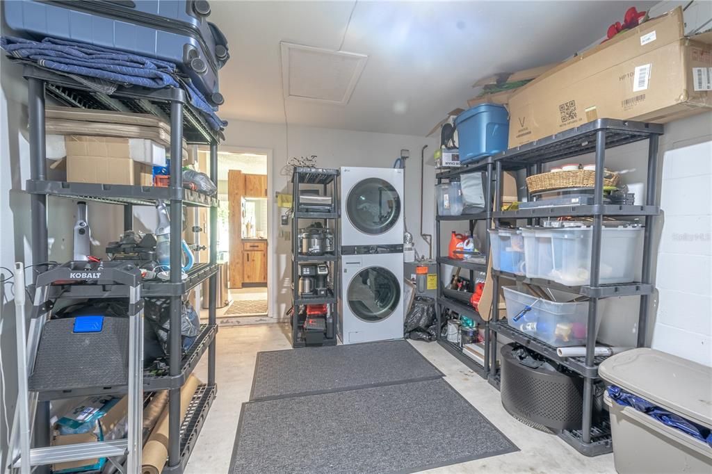 The garage has access to the attic, a new(smart) garage door with remote control and a convenient, dedicated space housing new (2023) LG ThinQ, stackable, smart washer/dryer.