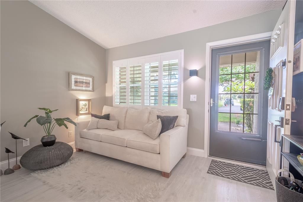 Plantation shutters and NEW neutral tone wood laminate flooring carried throughout the home for a seamless, cohesive 'model home' look.