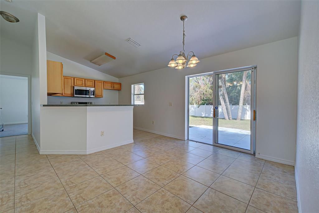 DINETTE AREA AND KITCHEN WITH PLENTY OF CABINETS AND COUNTER SPACE.