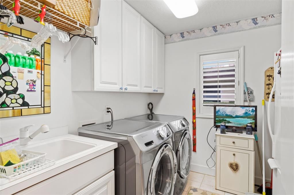 Laundry with sink, washer, dryer, refriderator and built ins