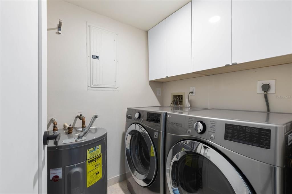 Fully finished laundry room with cabinets