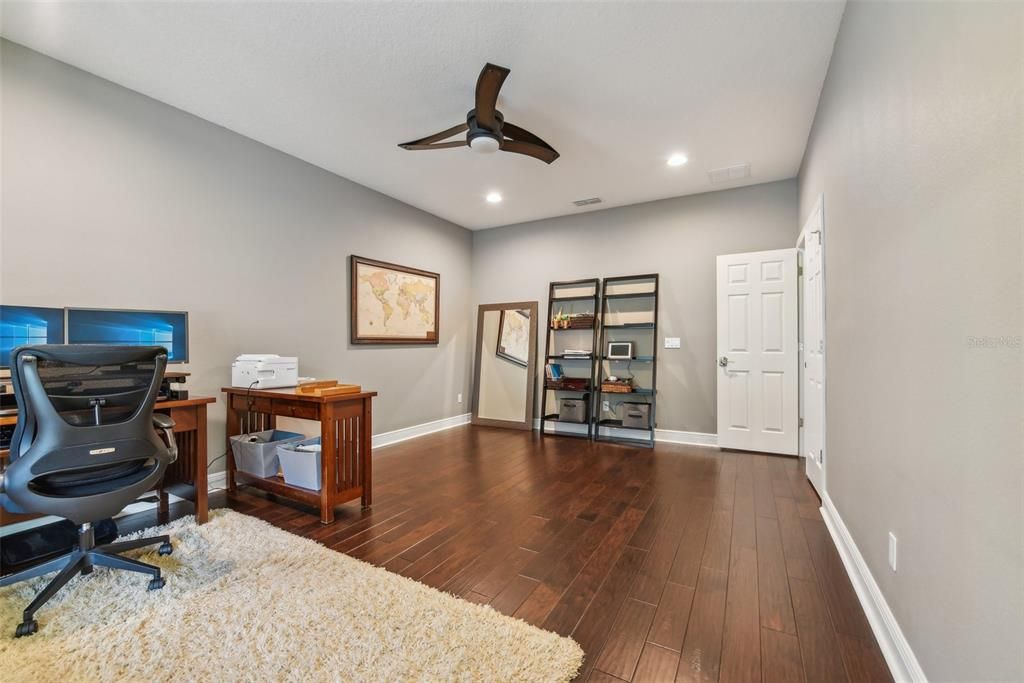 One of the Two Downstairs Bedrooms. Currently used as an office! Huge room that overlooks pool!