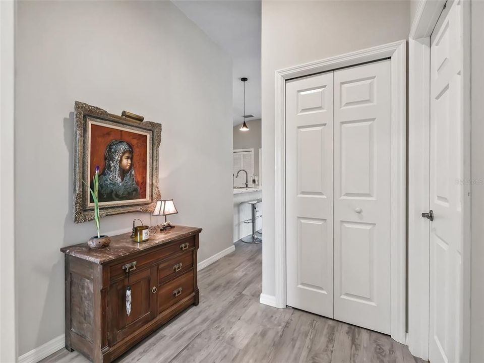 The foyer leading to the back of the home, linen closet and guest bath