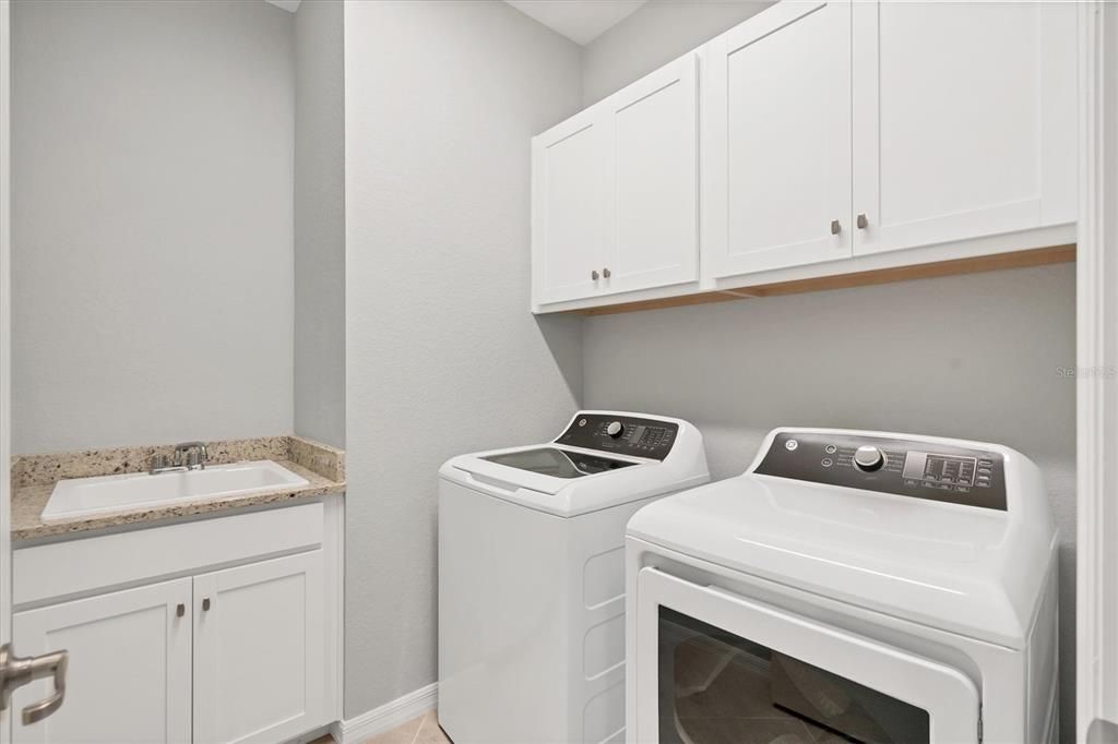 Laundry room with additional cabinets and sink