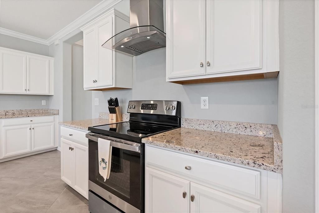 Kitchen with stainless steel vent hood